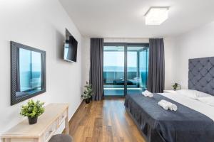 a bedroom with a bed and a mirror at Villa Twins in Crikvenica +73 photos