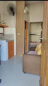 a small room with a bed and a kitchen at Villa Seresa Room A in Pagsanjan