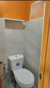 a bathroom with a white toilet in a room at Villa Seresa Room A in Pagsanjan