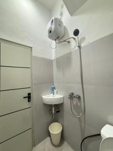a bathroom with a shower and a sink at Lovisya Residence in Jakarta