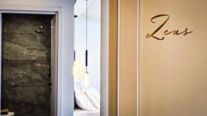 a door with the word less written on it at Costa Mare Rooms in Paralia Katerinis +43 photos