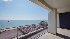 a balcony with a view of the ocean at Costa Mare Rooms in Paralia Katerinis