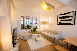 a living room with a couch and a table at Maison Lumière Arras in Arras