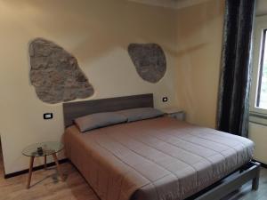 a bedroom with a bed and two hearts on the wall at Tra storia e realtà in Sardara +6 photos