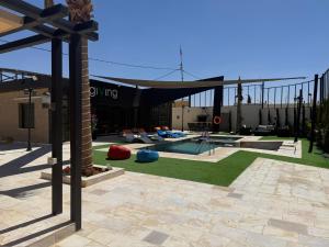 a backyard with a swimming pool and a building at Giving Vibes Chalet in Amman