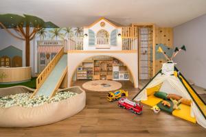 a childs play room with a doll house and toys at Katamaran Hotel & Resort Komodo in Labuan Bajo +48 photos