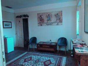 a living room with two chairs and a table at Tra storia e realtà in Sardara