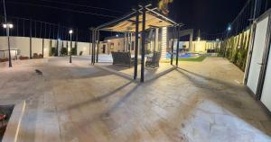 an empty patio at night with a cross on it at Giving Vibes Chalet in Amman