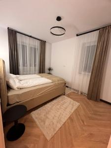 a bedroom with a bed and a large window at Aura Home - Livezeni Hiperbara in Livezeni +2 photos