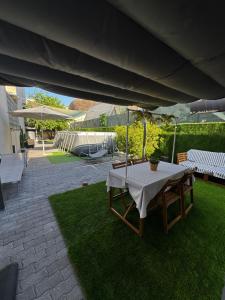 a patio with a table and chairs and an umbrella at SUITE Meghan home in Catania