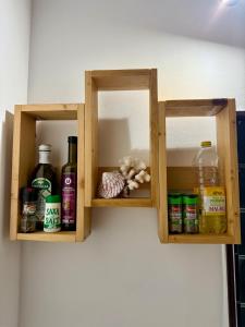 a wooden shelf with bottles and alcohol on a wall at Hanivai Beach Bungalow in HUH +44 photos