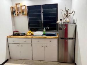 a kitchen with a refrigerator and a counter top at Hanivai Beach Bungalow in HUH