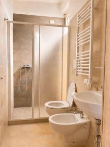 a bathroom with a toilet and a sink and a shower at Oasi Frontemare Appartamenti in Pineto