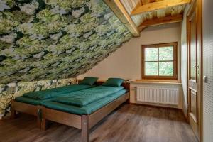 a room with a bed with a floral wall at Paegli Guest house in Kaijciems