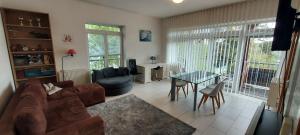 a living room with a couch and a table at Club Canada Lipno De Luxe in Lipno nad Vltavou