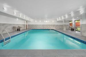 a swimming pool with blue water in a building at Hampton Inn Tracy in Tracy