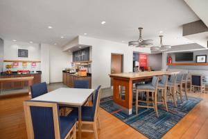 an open kitchen and dining room with tables and chairs at Hampton Inn Tracy in Tracy