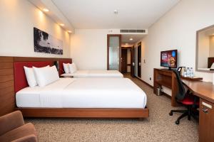 a hotel room with a bed and a desk and a computer at Hampton by Hilton Samsun in Samsun