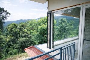 a balcony with a view of the mountains at Sindu Homestay in Kalasa