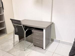 a desk with a chair and a computer desk with a drawer at Maatambaba Homes in Tamale