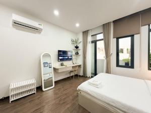 a bedroom with a bed and a desk and a computer at SP house in Ho Chi Minh City