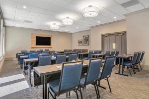 a conference room with tables and chairs and a tv at Country Inn & Suites by Radisson, Metairie New Orleans , LA in Metairie +84 photos