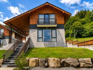 a house with a staircase leading to it at Crown Villa Bakuriani in Bakuriani