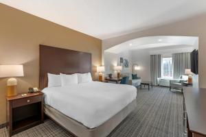 a hotel room with a large bed and a living room at Comfort Inn & Suites Verona at Turning Stone Resort Casino in Verona +34 photos