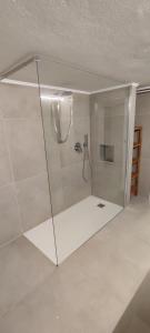 a shower with a glass door in a bathroom at Villa Lidia, Como Lake in Colico +35 photos