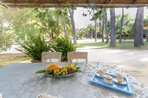 a table with a bowl of fruit on it at Villa Riggia in Nardò