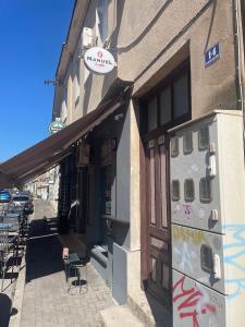 a building with parking meters on the side of it at Apartman Amela in Mostar