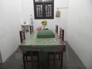 a table with a green table cloth and a sink at Breezy Villa - Arugambay in Arugam Bay