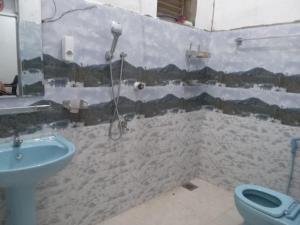 a bathroom with a shower and a sink and a toilet at Breezy Villa - Arugambay in Arugam Bay