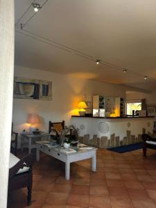 a living room with a table and a couch at Boutique Hotel Sant'Andrea & Relais in San Pantaleo