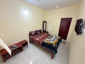 a small bedroom with a bed and a tv at Gravity Groups VVJ - Jipmer Sangamithra in Puducherry Airpoert