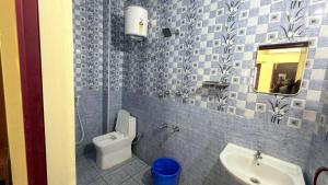 a bathroom with a toilet and a sink at Gravity Groups VVJ - Jipmer Sangamithra in Puducherry Airpoert