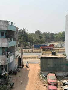 a dirt road next to a building with cars on it at Gravity Groups VVJ - Jipmer Sangamithra in Puducherry Airpoert +24 photos