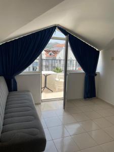 a living room with a couch and a large window at Atlantis Apart in Marmaris