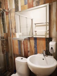 a bathroom with a sink and a mirror and a toilet at Гостевой дом Discovery in Almaty +29 photos