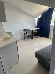 a room with a table and chairs and a sink at Atlantis Apart in Marmaris