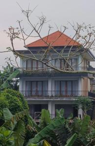 a large house with a red roof at Jagadhita sekembang ubud in Ubud