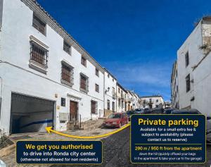 a building with a parking sign in front of it at Las Vistas Residence - Best Views in Ronda in Ronda
