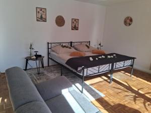 a living room with a bed and a couch at Apartment Aigner in Reisbach