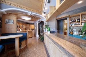 a bar with a wooden counter in a room at Hotel Centrale in Auronzo di Cadore