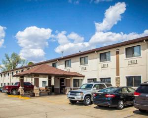 a large building with cars parked in a parking lot at Quality Inn Forsyth Decatur in Forsyth