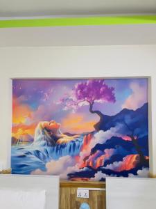a painting of a waterfall and a tree on a wall at Hotel Mirana Pvt Ltd in Kathmandu
