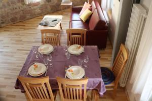 a dining room table with chairs and a purple table cloth at Blaues Haus in Edenkoben