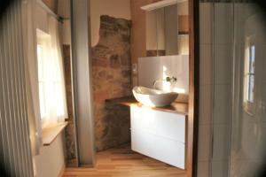 a bathroom with a sink on a counter with a window at Blaues Haus in Edenkoben
