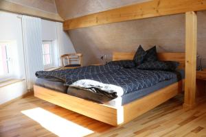 a bedroom with a large bed with a wooden frame at Blaues Haus in Edenkoben