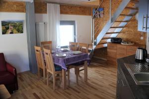 a kitchen and dining room with a table and chairs at Blaues Haus in Edenkoben